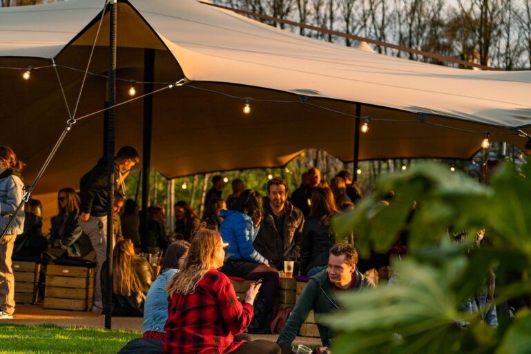 A crowd shot of the bar area at dusk at the Paisley Food and Drink Festival 2023.