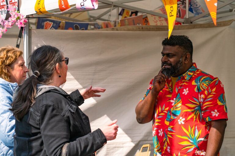 A vendor talking to people at Paisley Food and Drink Festival 2023.