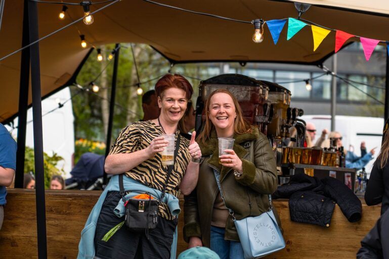 Two people enjoying a drink at Paisley Food and Drink Festival 2023.