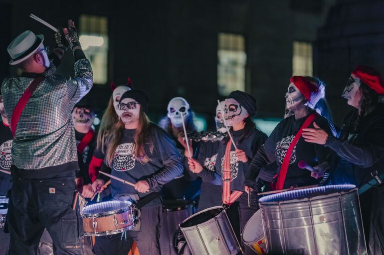 A samba band perform with steel drums at Paisley Halloween Festival 2023.