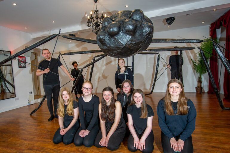 Starlight Musical Theatre pose with giant spider puppet which will appear at Paisley Halloween Festival 2022