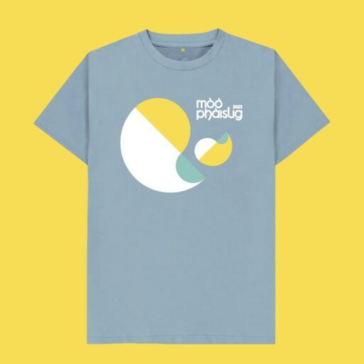 Light blue t-shirt on a yellow background with the Mòd Phàislig 2023 logo across the chest.