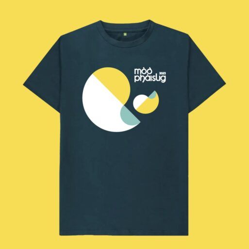 Denim blue t-shirt on a yellow background with the Mòd Phàislig 2023 logo across the chest.
