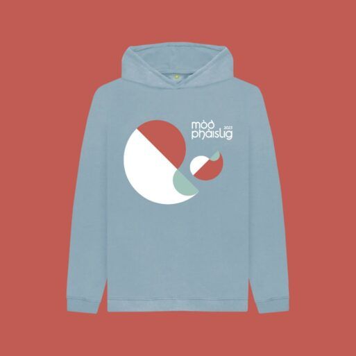 Light blue hoodie on a coral coloured background with the Mòd Phàislig 2023 logo across the chest.