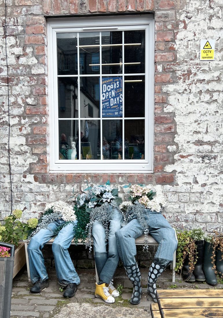 jeans on a bench with flowers