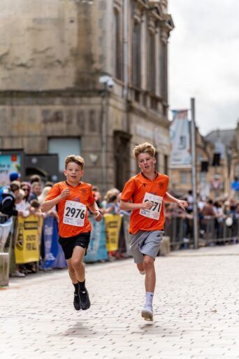 Two boys running in Paisley 3k Fun Run 2023